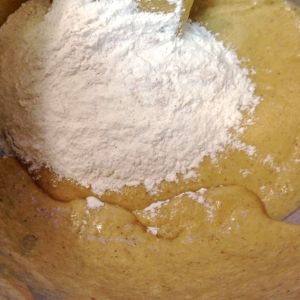 Adding in the last third of the flour mixture.